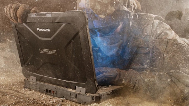 A Panasonic Toughbook rugged laptop being used in a dusty outdoor environment.