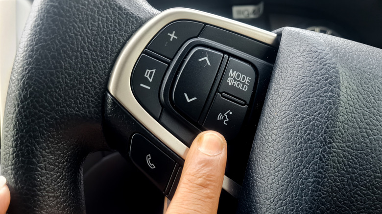 Steering wheel voice-command button.