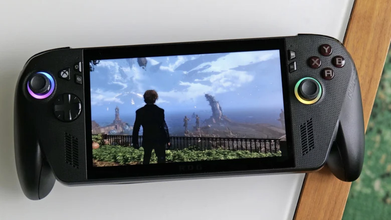 Photo of the ASUS ROG Xbox Ally X. A black gaming handheld, screen showing a third-person view of a man looking over a large body of water.