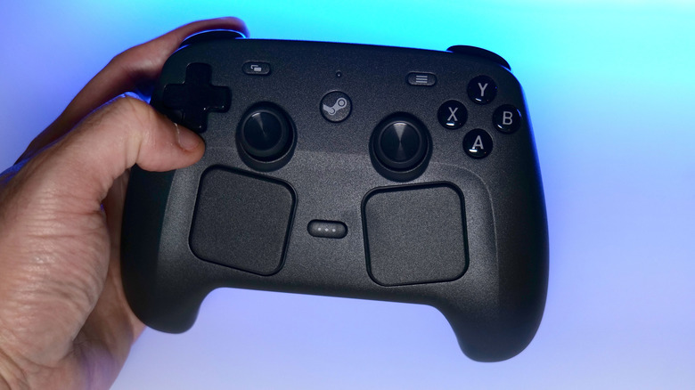 Steam Controller held by Sam Rutherford.