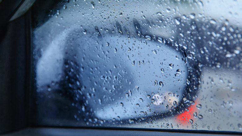 Rain collects on a car's window.