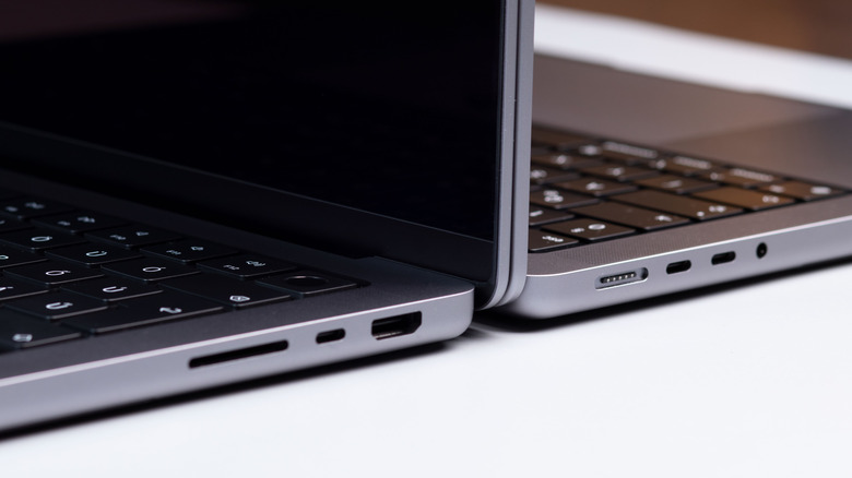 Laptop with one USB-C port next to another with two USB-C ports.
