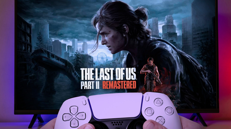 The Last of Us Part 2 logo on a TV with a controller held up in front of it