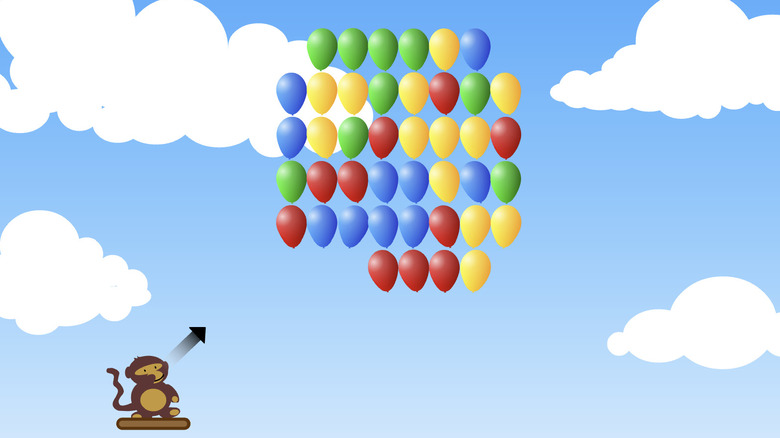 A monkey sits on a platform in the sky with a few dozen multicolored balloons above him in a 2D game.