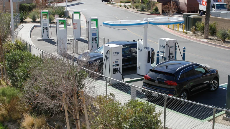 A pair of vehicles charging at an EVgo station on a sunny day.