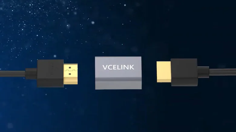 Two HDMI cables connect to a VCELINK HDMI coupler against a starry blue background.