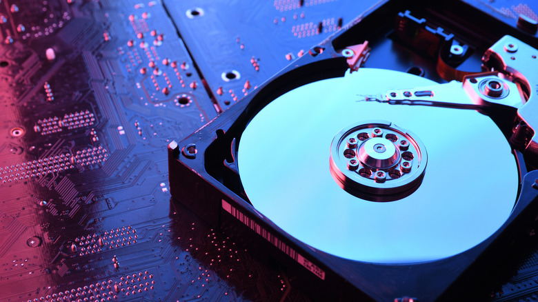A hard drive placed on top of a circuit board.