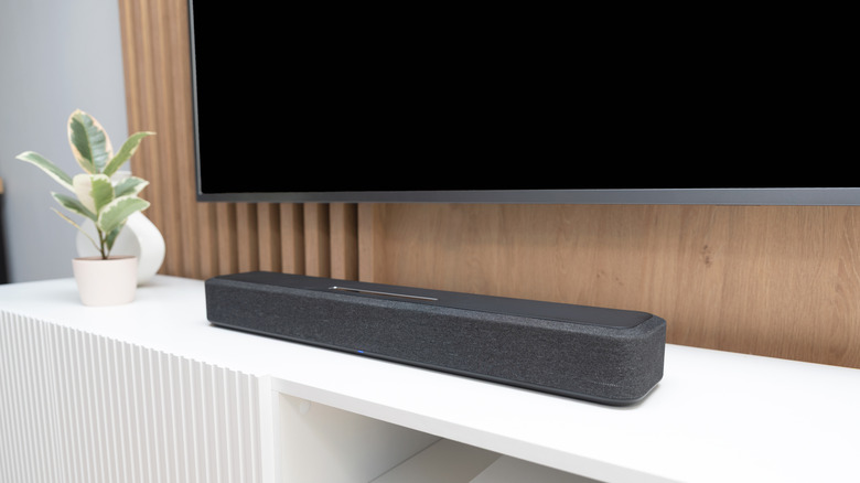A soundbar placed beneath a television.