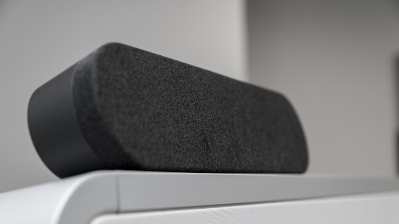 A black soundbar and TV remote.