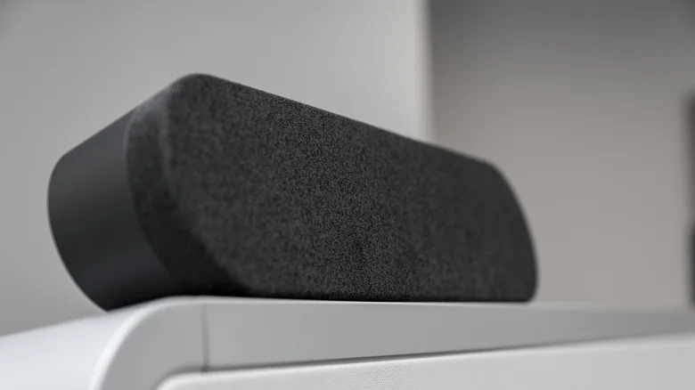 A black soundbar and TV remote.