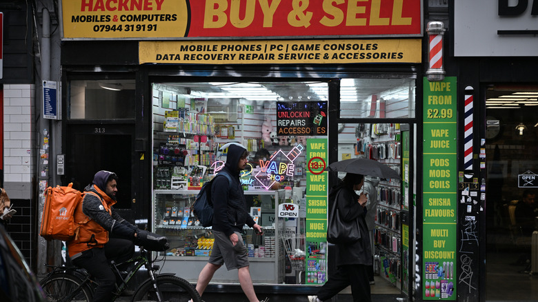 Outside of a mobile phone repair and exchange shop in London, UK.