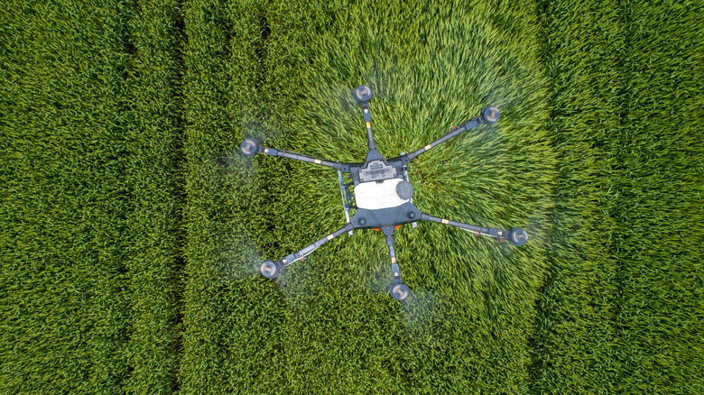 A large crop-spraying drone is shown from above