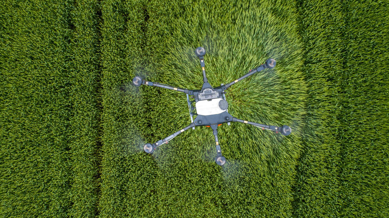 A large crop-spraying drone is shown from above