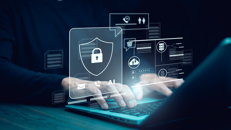 Stock image of someone typing on a laptop with scary internet security symbols hovering above
