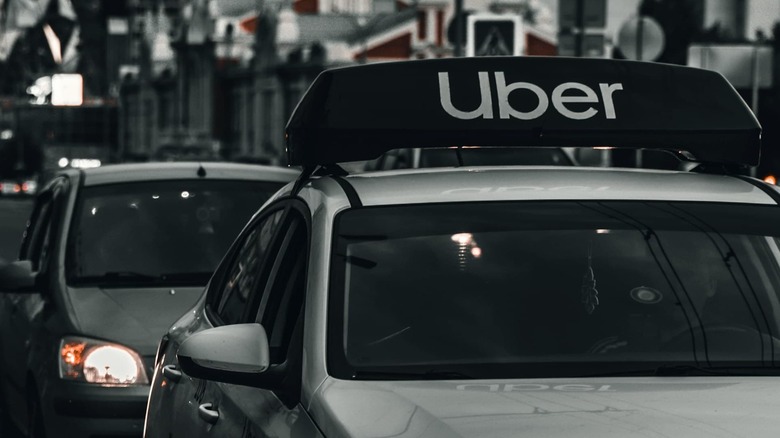 Uber sign on top of a car