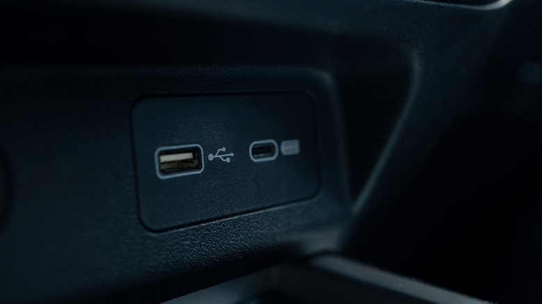 A USB-A and USB-C port side-by-side in a vehicle.