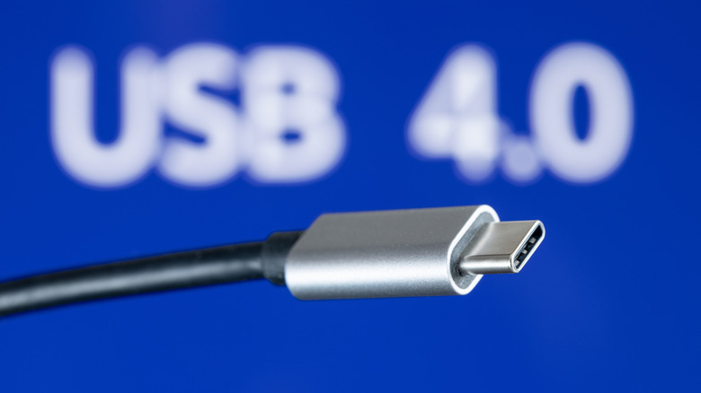A USB4 cable against a blue backdrop.