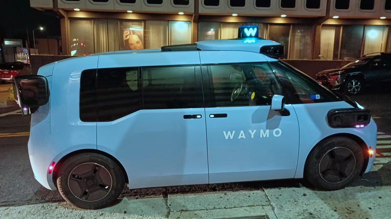 A Waymo Ojai robotaxi on a city street.