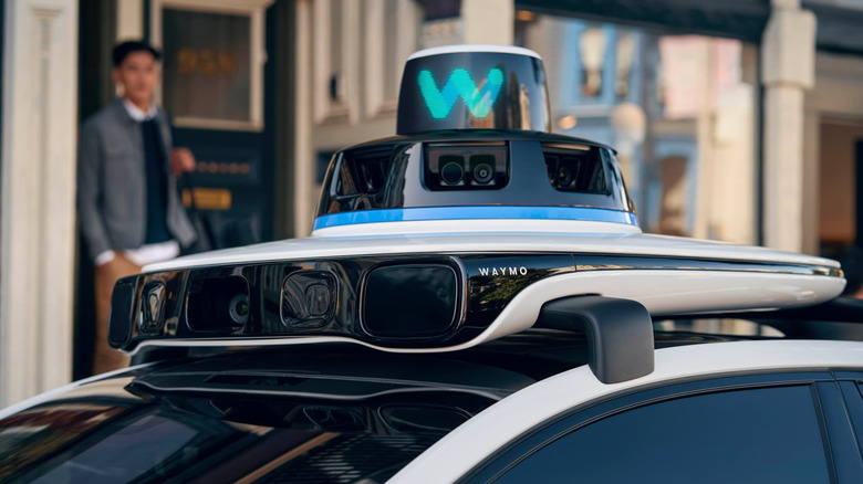 Waymo sensor system attached the the top of a vehicle.