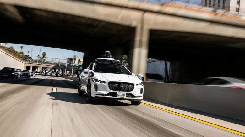 A Waymo robotaxi running in a freeway.