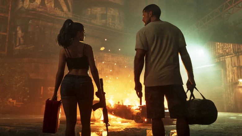 Jason and Lucia, holding cases and weapons, look at each other before a burning car in a dark warehouse.
