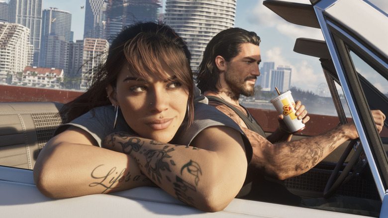 GTA 6's Jason drives his convertible down a highway while Lucia leans out the window.