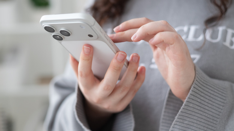 Close-up of person using iPhone 17 Pro.