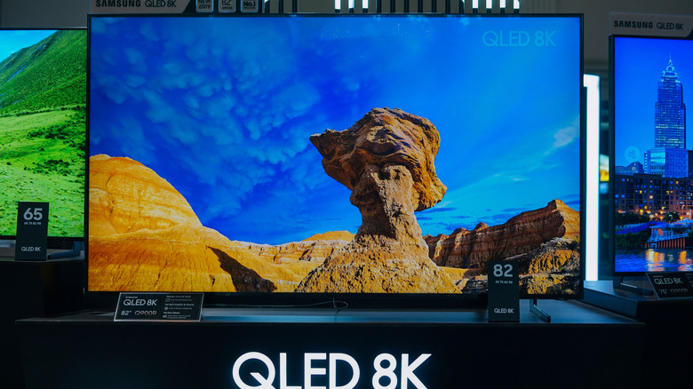A QLED 8K TV with HDR support, on sale in a retail store.