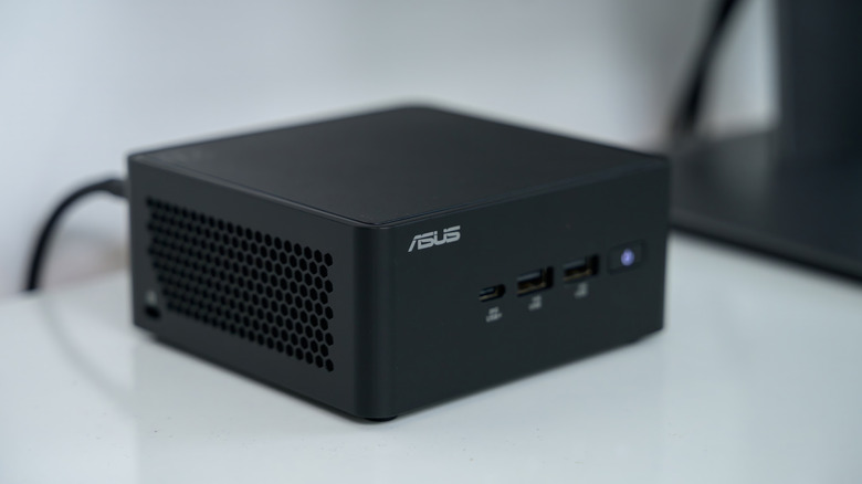 A closeup view of an Asus NUC mini PC on a desk.