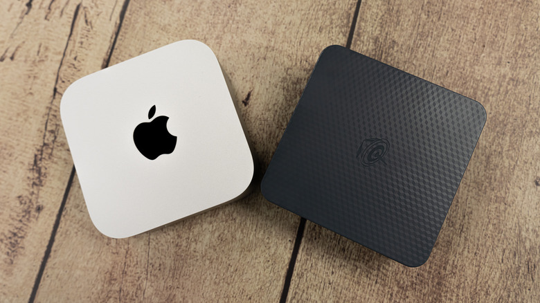 An Apple Mac Mini positioned next to a Beelink mini PC