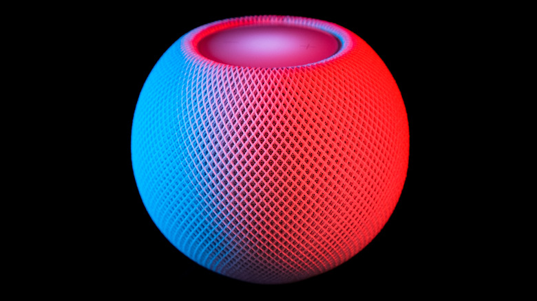 Apple's HomePod mini with a light glow on it.