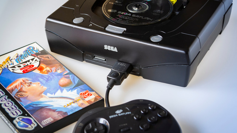Sega Saturn console with Street Fighter game disc.