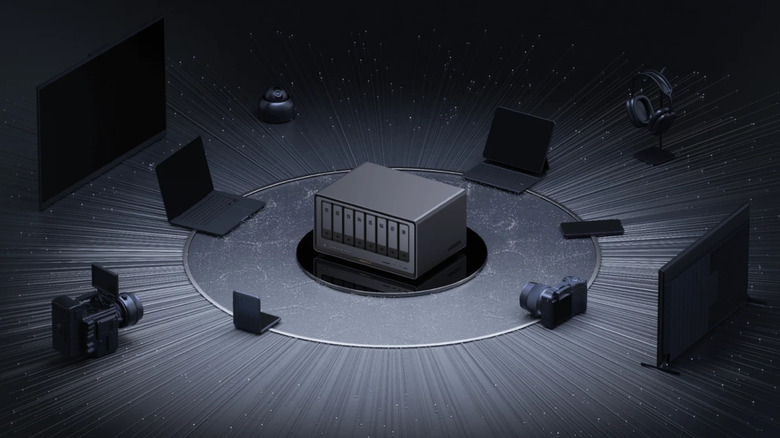 Product image of Ugreen NAS surrounded by laptops and cameras.