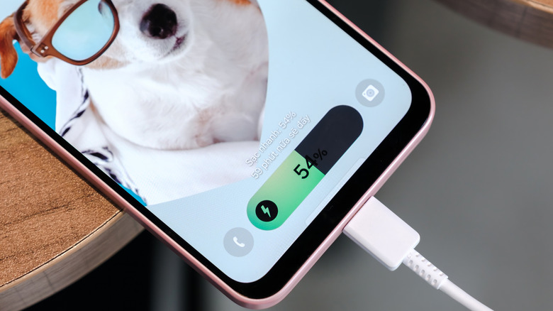 A Samsung Galaxy phone plugged in and charging.