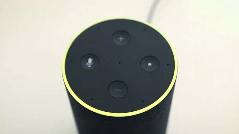An Amazon Echo device glows yellow, lighting up the full ring.