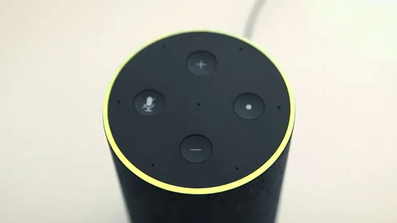 An Amazon Echo device glows yellow, lighting up the full ring.