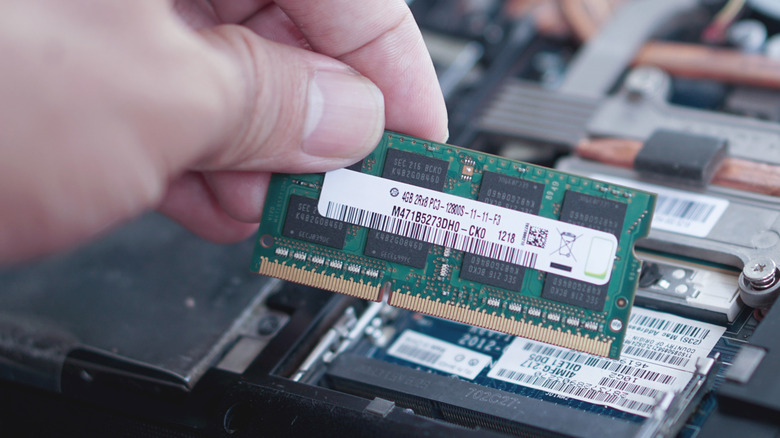 Person holding a laptop memory stick.