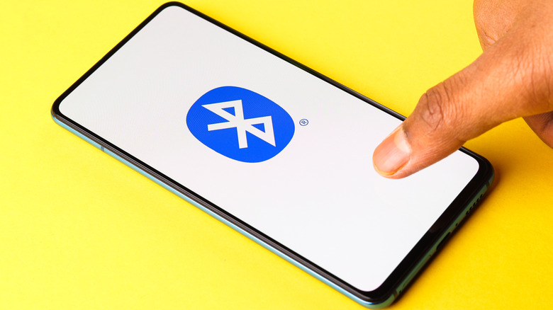 Big Bluetooth logo on a phone screen, with a finger coming in from the right
