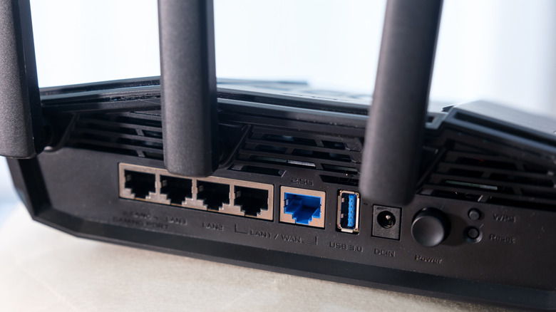 Rear view of an entry-level TUF Gaming BE3600 dual-band gaming router with four Ethernet LAN ports, a single blue Ethernet WAN port and a USB 3.0 port.