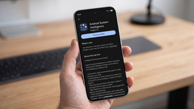 A phone displaying the Android System Intelligence app in the Google Play Store.