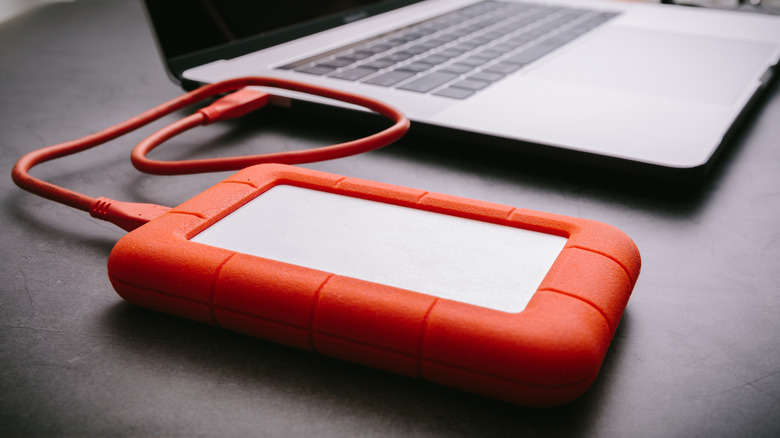 An external hard drive connected to a laptop.