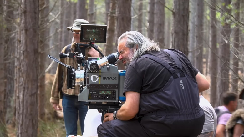 A cameraman stars into the massive IMAX camera during filming