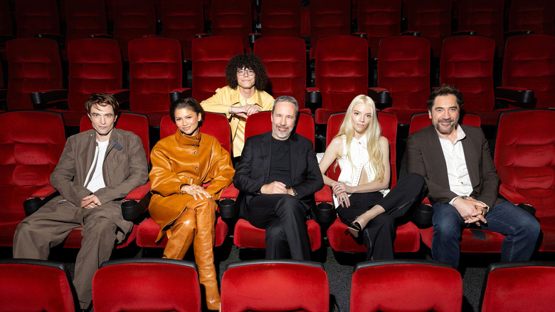 The cast of Dune: Part 3 sits together in a bright, red chaired theater.
