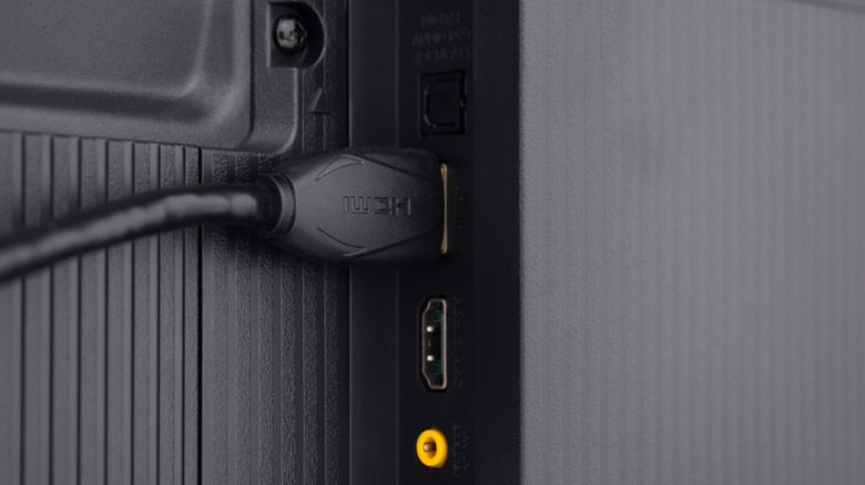Photo of an HDMI cable plugged into back of a TV.
