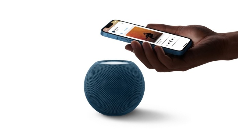 Transferring music from an iPhone to a blue HomePod mini.