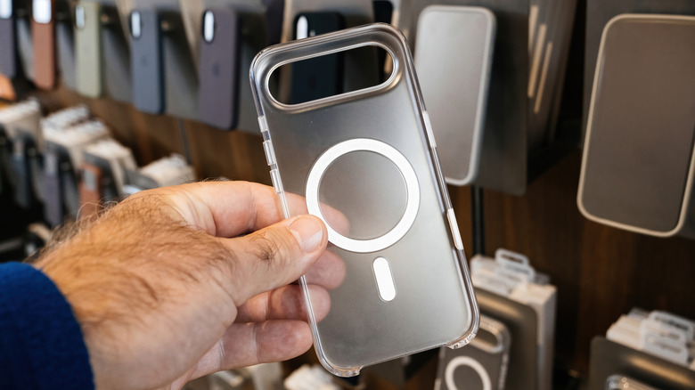 A person holds a transparent MagSafe case.