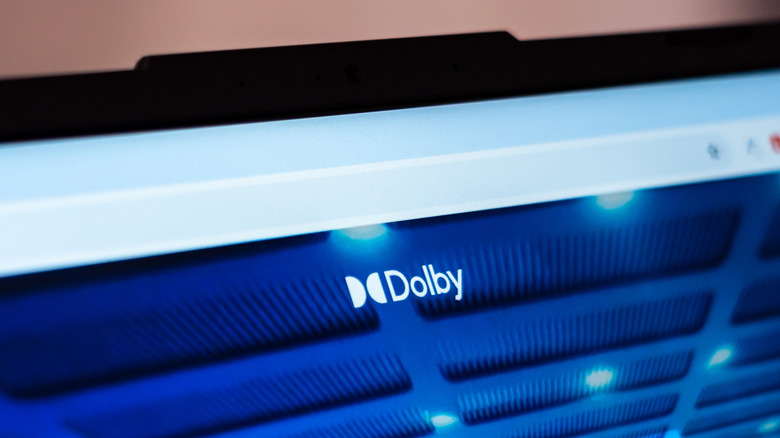 Dolby logo displayed on a screen with a blue interface in the background.