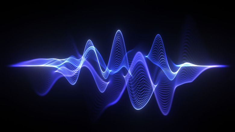 Abstract blue and purple sound wave visualization against a dark background.