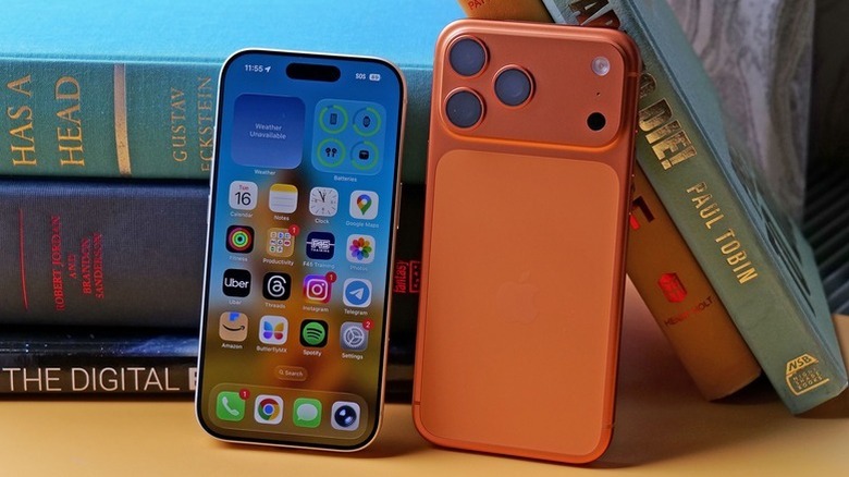 iPhone 17 Pro and 17 Pro Max posed on table with books
