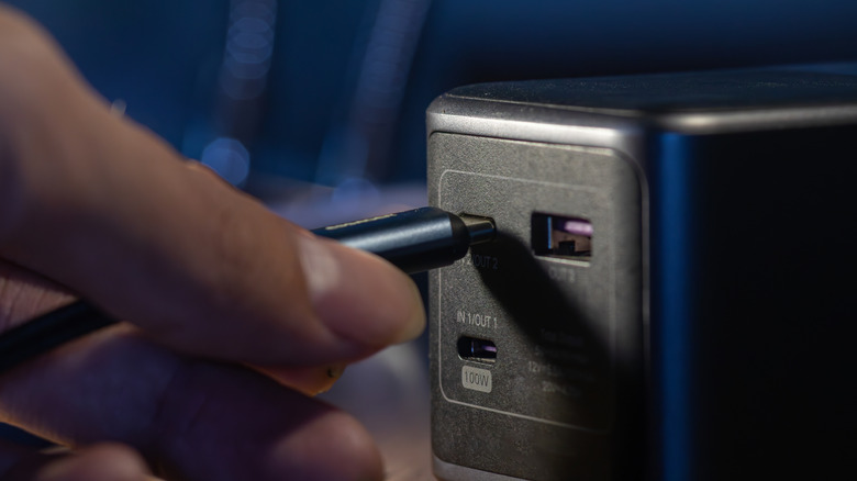 A USB-C cable being plugged into a charging brick